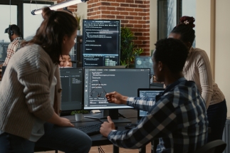students studying in front of multiple screens