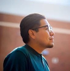 headshot-of-man-wearing-glasses-and-black-shirt