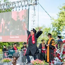 student-in-cap-and-gown-celebrating