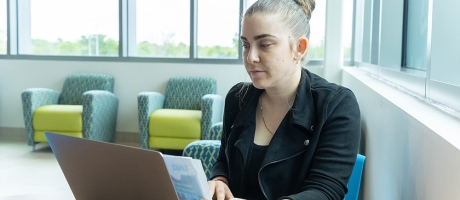Female student working on her laptop