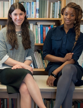 Two female student sitting on a table