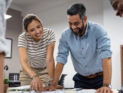 two people looking at data on a laptop