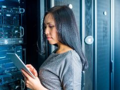 systems engineering student working in front of servers