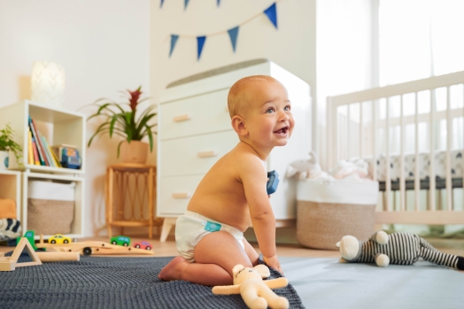 Happy baby wearing Charlie banana diaper image