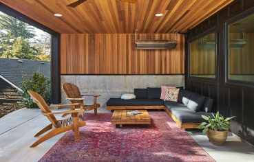 Patio with fireplace with tv mounted and furniture