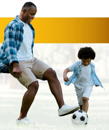 Dad playing soccer with his son