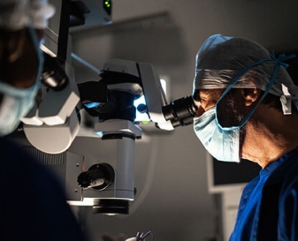 Doctor looking though machine
