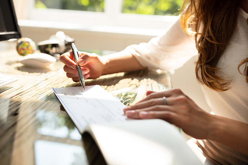 person writing a check