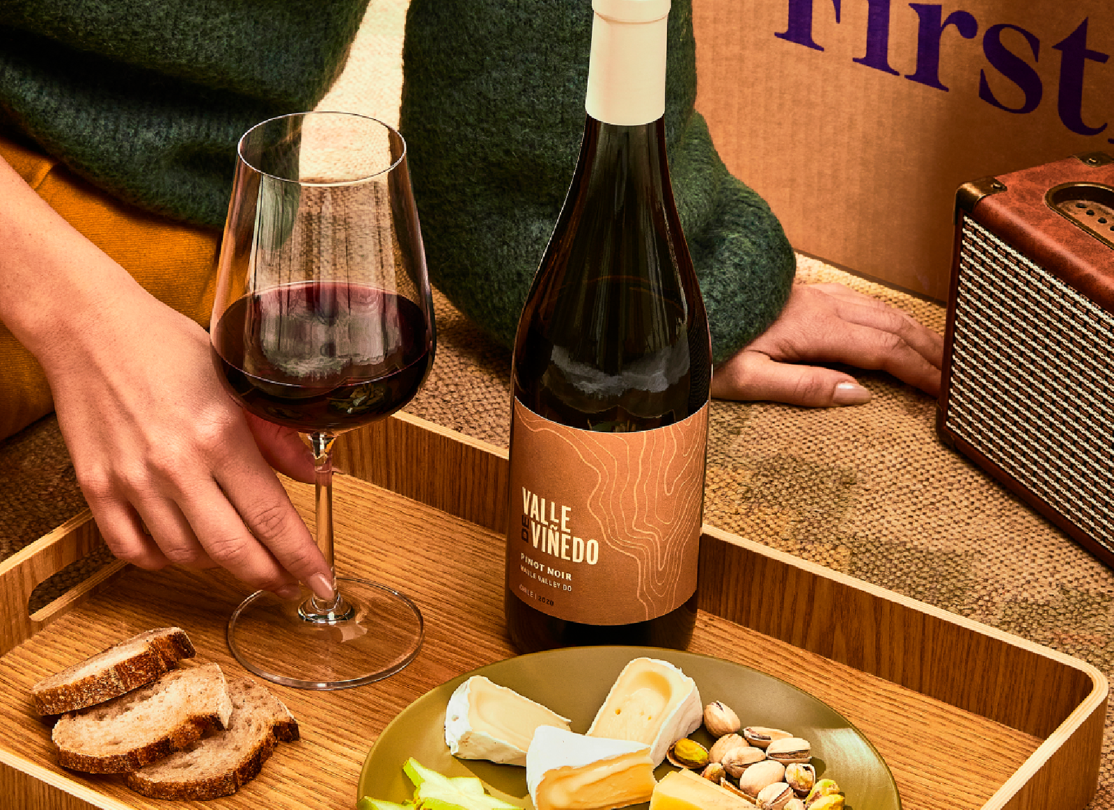person drinking firstleaf red wine and eating cheese
