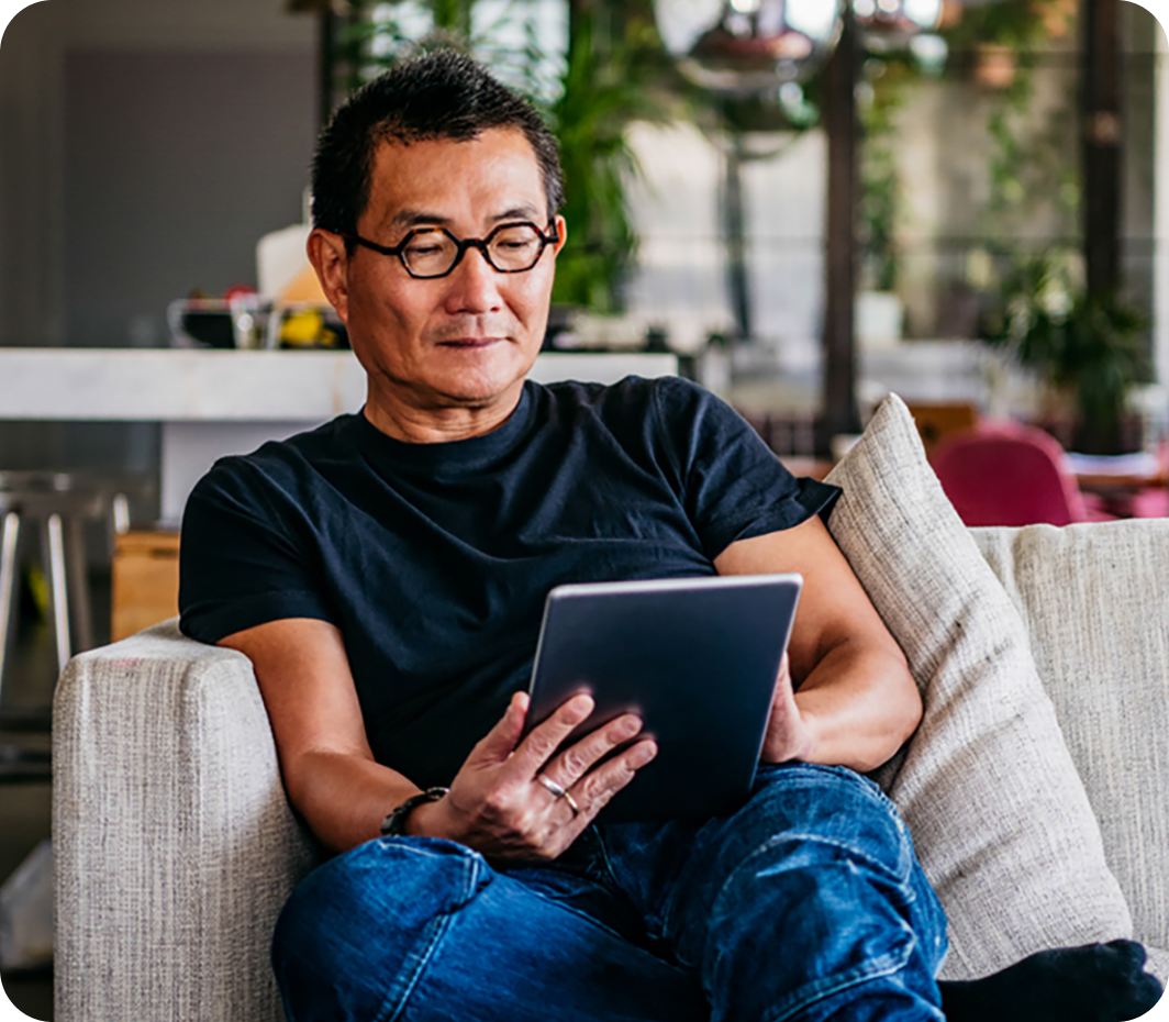 Man on couch using tablet