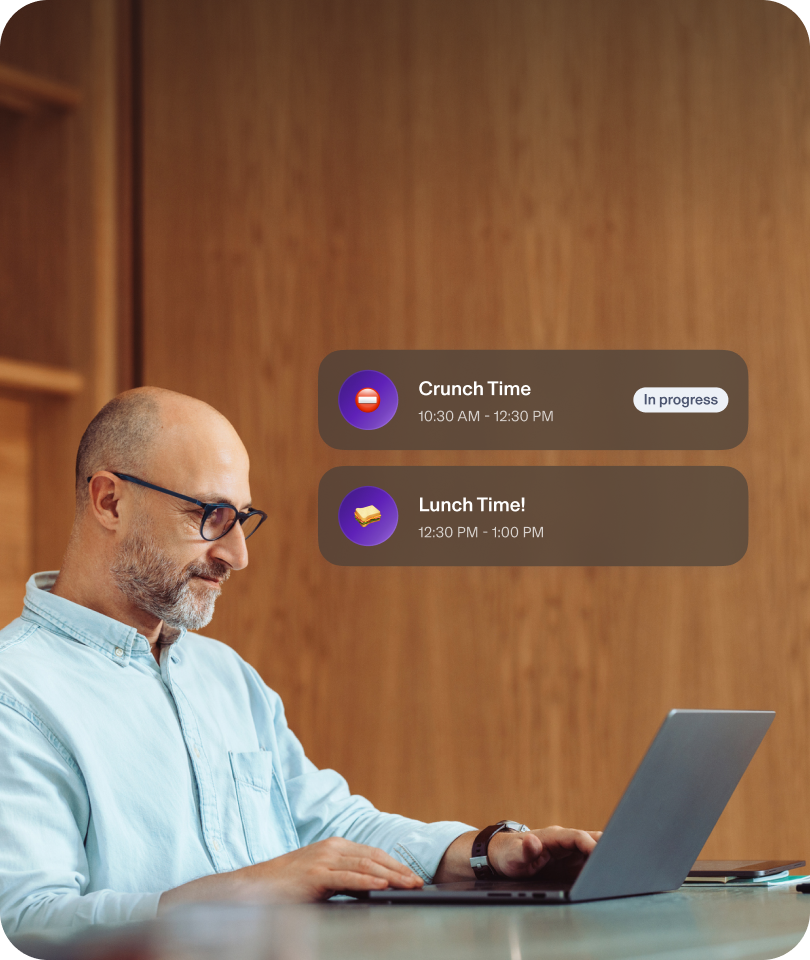 Man using computer, showing Crunch Time and Lunch Time popups.