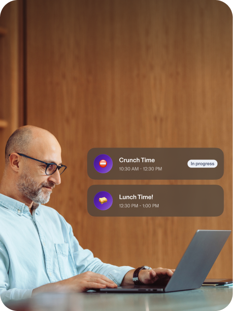 Man using computer, showing Crunch Time and Lunch Time popups.