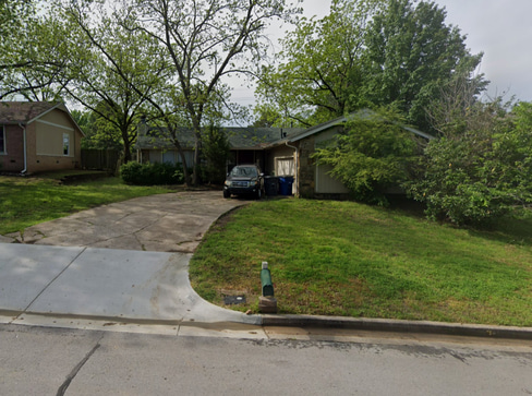 Older single-story home with worn exterior, suitable for renovation or cash purchase.