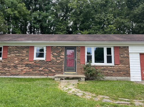 Single-story home with visible exterior wear, ideal for a fixer-upper purchase.