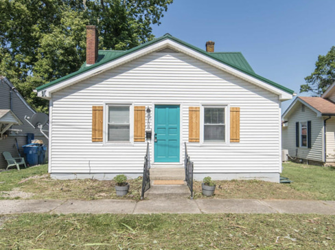 Single-story home with visible exterior wear, ideal for a fixer-upper purchase.
