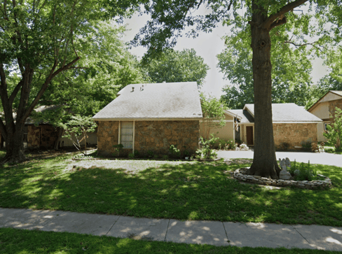 Single-story home with dated exterior and minimal landscaping, ideal for a fixer-upper sale.