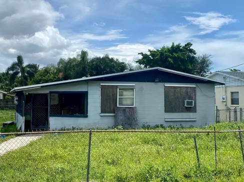 Single-story home with visible exterior wear, ideal for a fixer-upper purchase.
