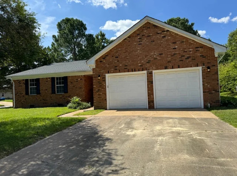 Older home with carport and desert landscaping, suitable for an as-is home sale.
