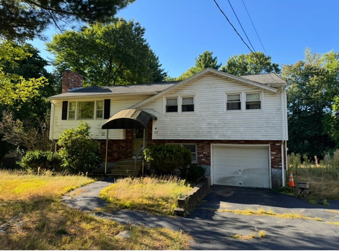 Older single-story home with worn exterior, suitable for renovation or cash purchase.