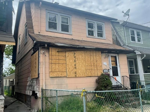 Single-story home with visible exterior wear, ideal for a fixer-upper purchase.