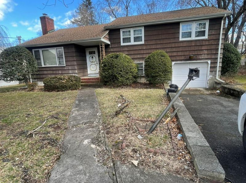 Older single-story home with worn exterior, suitable for renovation or cash purchase.