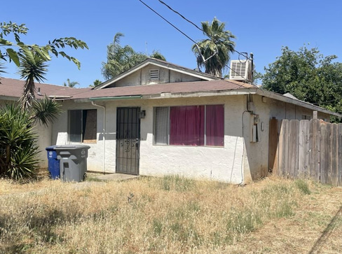 Single-story home with visible exterior wear, ideal for a fixer-upper purchase.