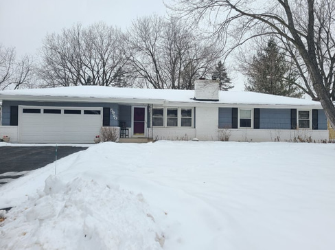 Single-story home with dated exterior and minimal landscaping, ideal for a fixer-upper sale.