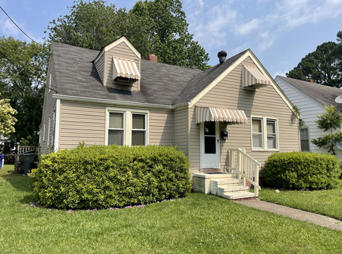 Single-story home with visible exterior wear, ideal for a fixer-upper purchase.