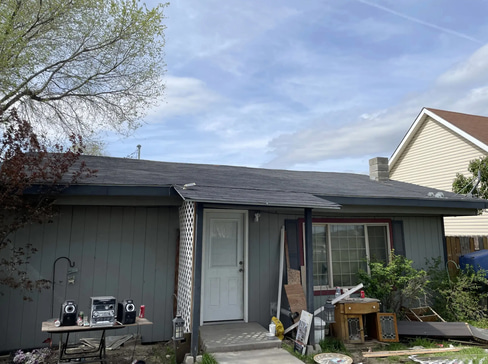 Older home with a detached carport and worn exterior, suitable for renovation or cash sale.