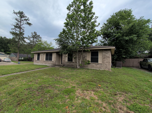 Older single-story home with worn exterior, suitable for renovation or cash purchase.