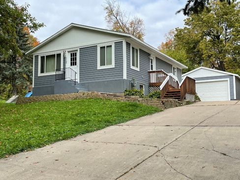 Single-story home with visible exterior wear, ideal for a fixer-upper purchase.