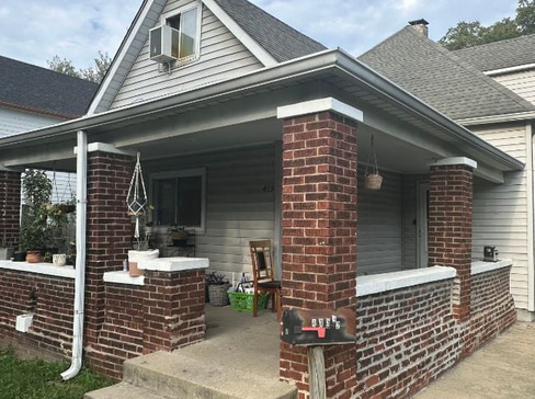 Older single-story home with worn exterior, suitable for renovation or cash purchase.