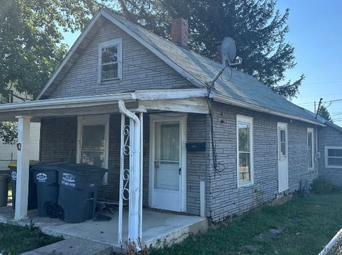 Single-story home with worn exterior and minimal curb appeal, ideal for a quick home sale.
