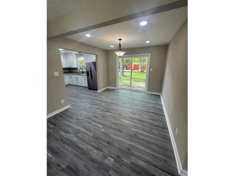 Single-story home with dated exterior and minimal landscaping, ideal for a fixer-upper sale.