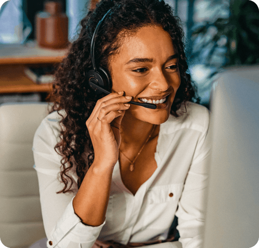 Lady answering call to give best in class fraud support smiling