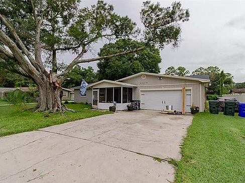 Single-story home with visible exterior wear, ideal for a fixer-upper purchase.