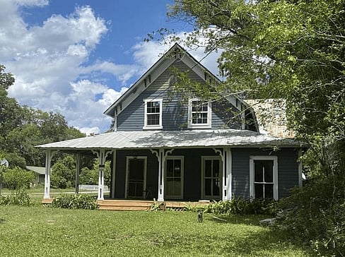 Older single-story home with worn exterior, suitable for renovation or cash purchase.
