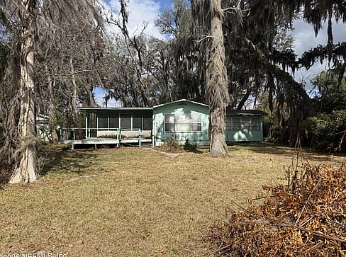 Single-story home with visible exterior wear, ideal for a fixer-upper purchase.