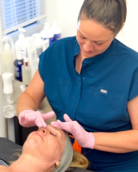 woman receives luxurious facial by an aesthetician