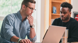 Two William & Mary Students working at a laptop