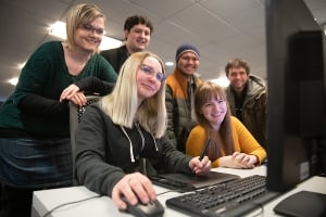 Group of students around a computer