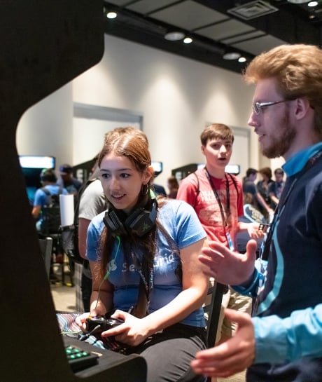 DigiPen Student playing a game at an arcade cabinet
