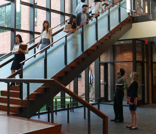 students on stairway headed to classes