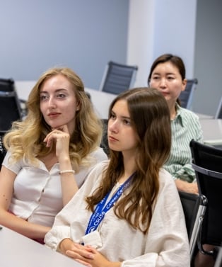 A group of female students listening to professor in class.
