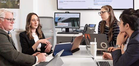 Group of professionals and students sitting around a table have a meeting
