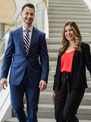 Two students walking down a staircase