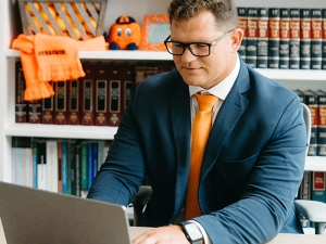 Syracuse student working at his laptop