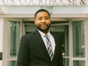 Syracuse student in front of a U.S. Courthouse