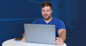 University of New Haven student working at his laptop