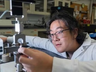 Close-up of male engineer aligning a test sample.